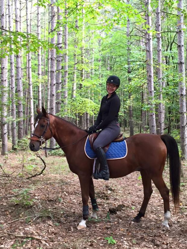 Elise and Joker doing his favorite thing: trail riding!